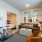 living area connected to a bedroom includes ample seating spaces and bright lighting