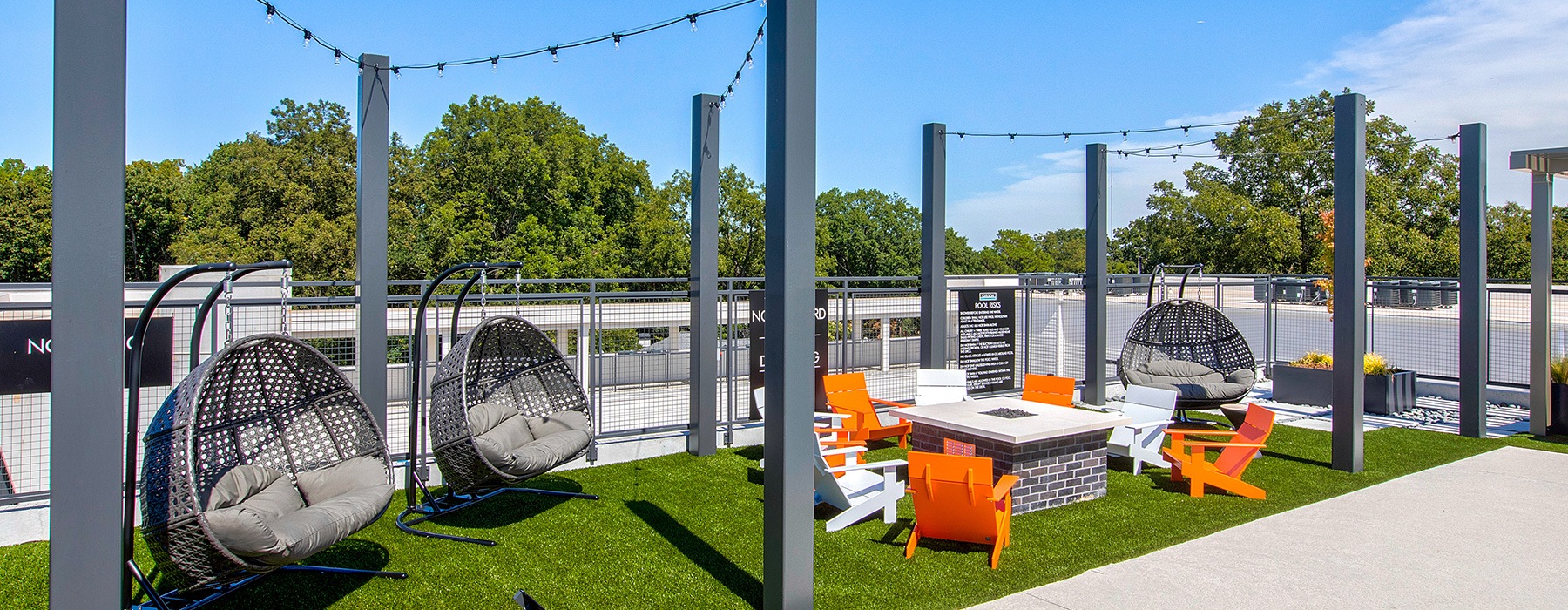 spacious outdoor seating with a firepit and on green turf
